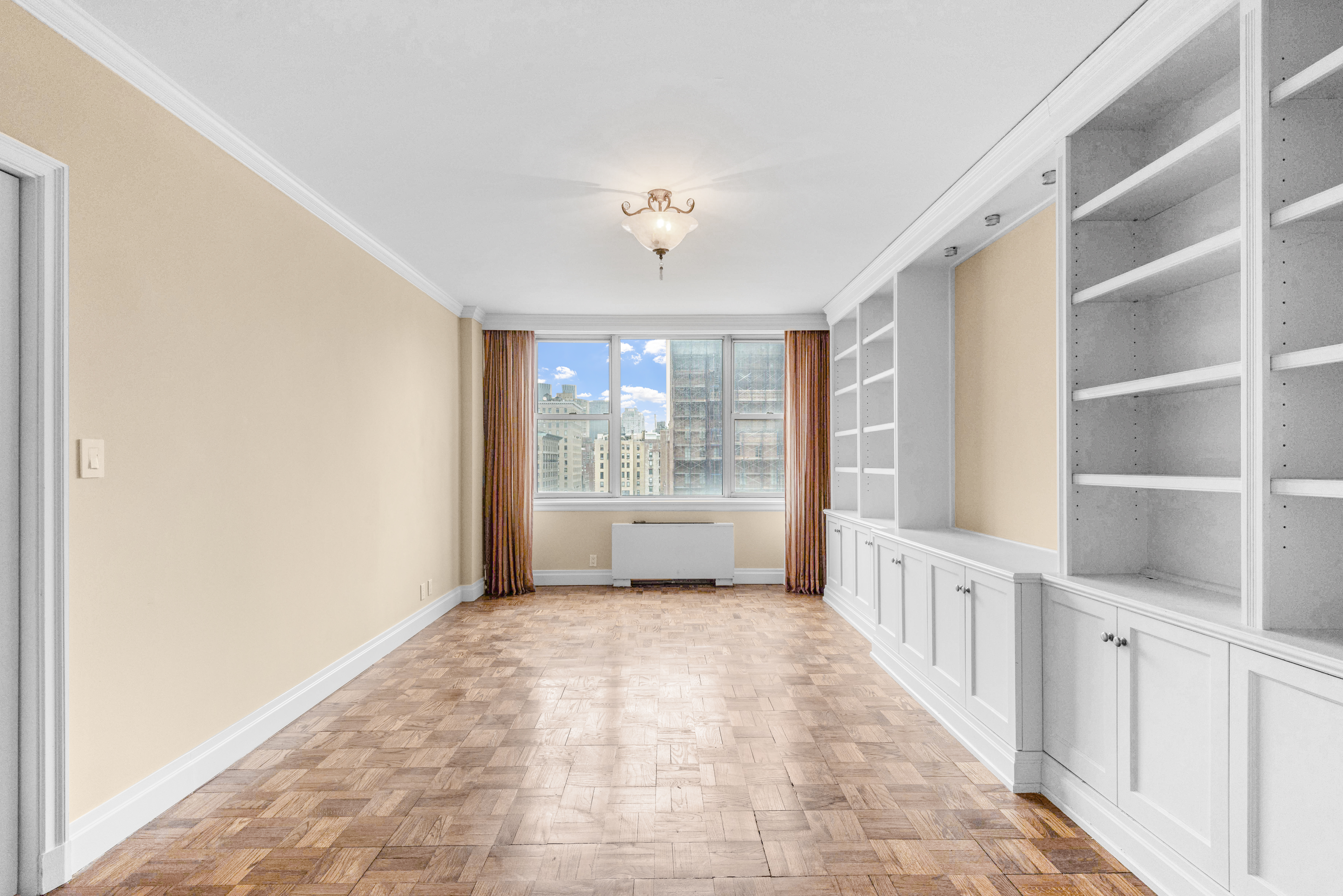 175 East 62nd Street, Unit 12A Manhattan, NY 10065 - Photo 16 of 24 a view of an empty room with a window