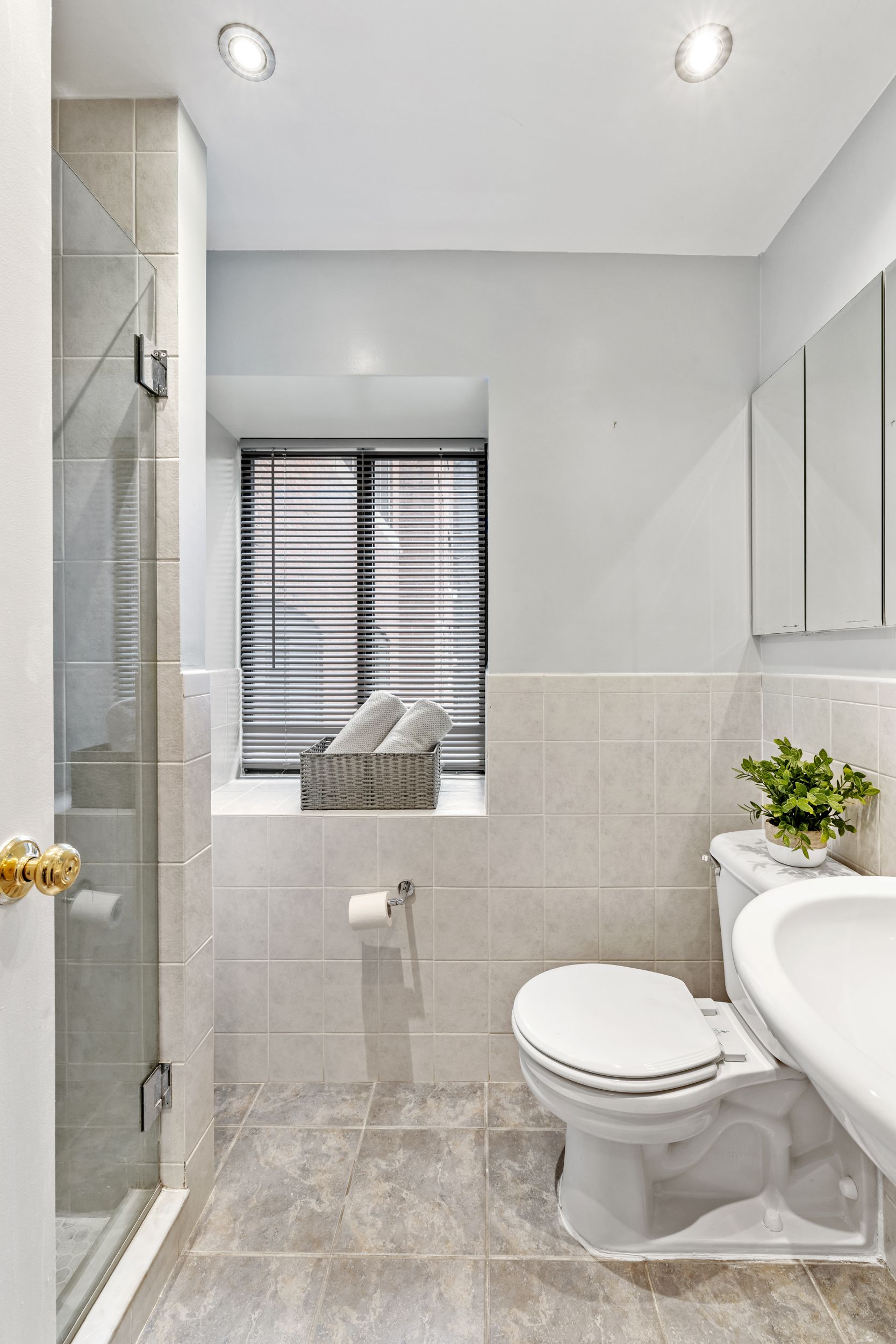 248 East 31st Street, Unit 4A Manhattan, NY 10016 - Photo 11 of 14 a bathroom with a toilet a sink and shower