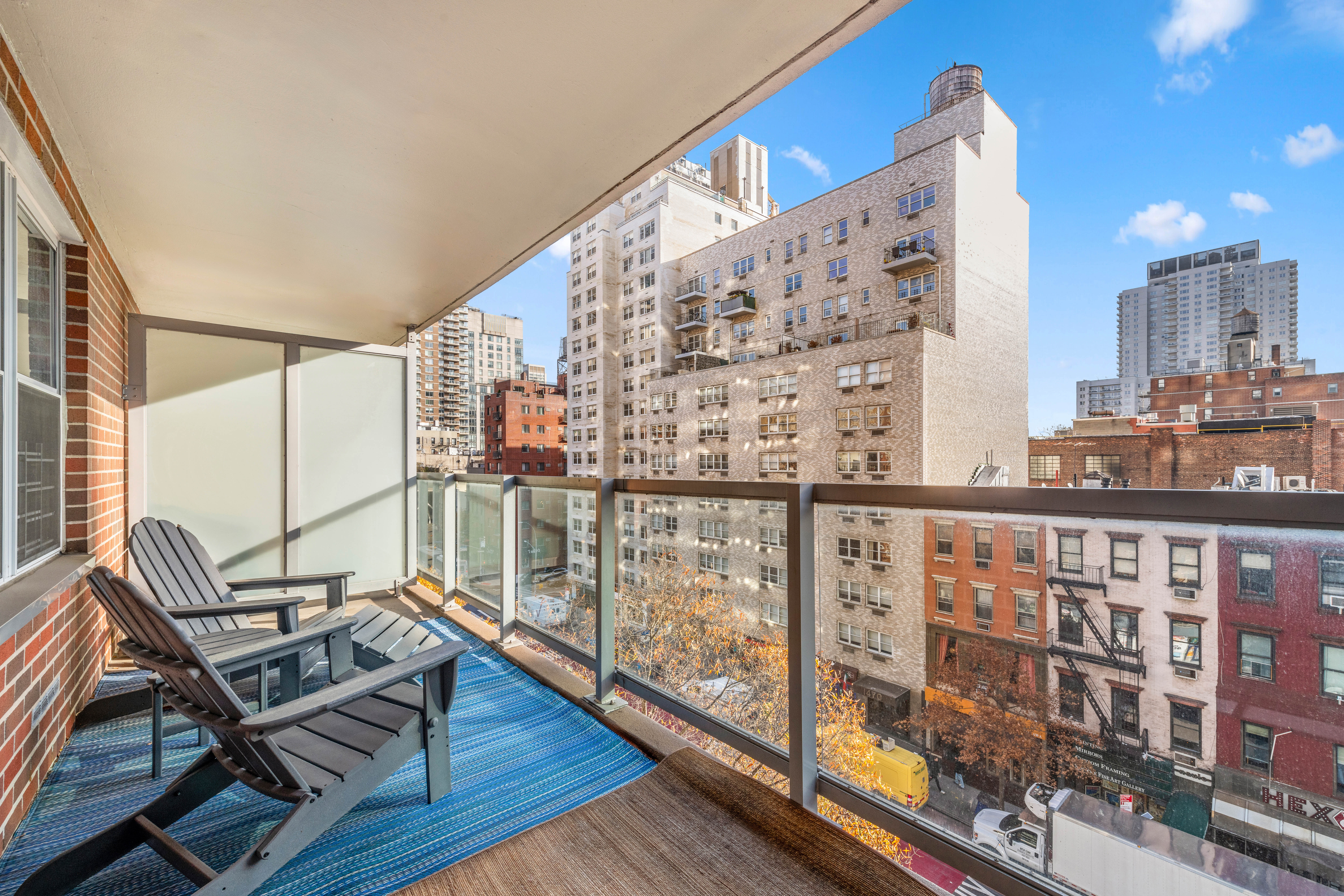 363 East 76th Street, Unit 7C Manhattan, NY 10021 - Photo 12 of 19 a view of balcony with two chairs and wooden floor