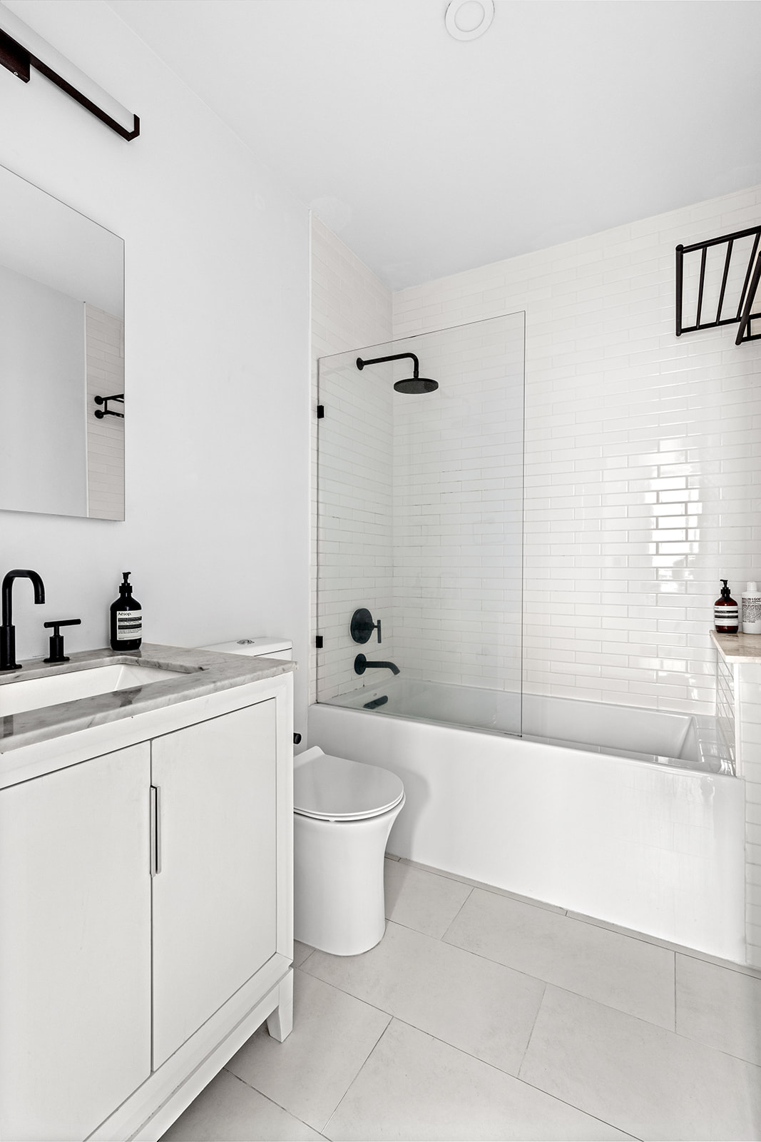 167 Perry Street, Unit 5F Manhattan, NY 10014 - Photo 3 of 12 a bathroom with a toilet a sink and bathtub
