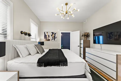 a large white bed in a white room