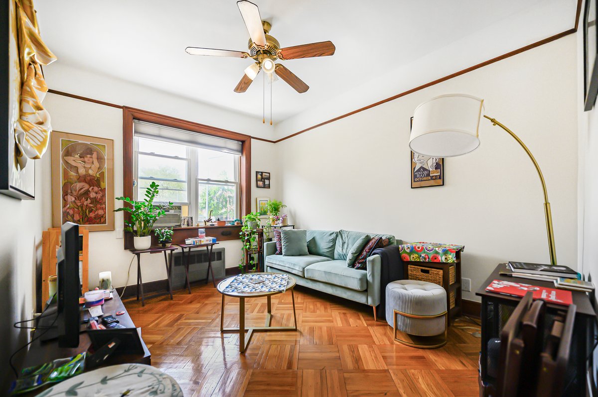 1702 11th Avenue Brooklyn, NY 11218 - Photo 12 of 25 a living room with furniture a flat screen tv and a large window