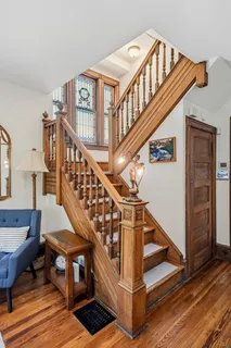 a view of an entryway with wooden floor and a livingroom