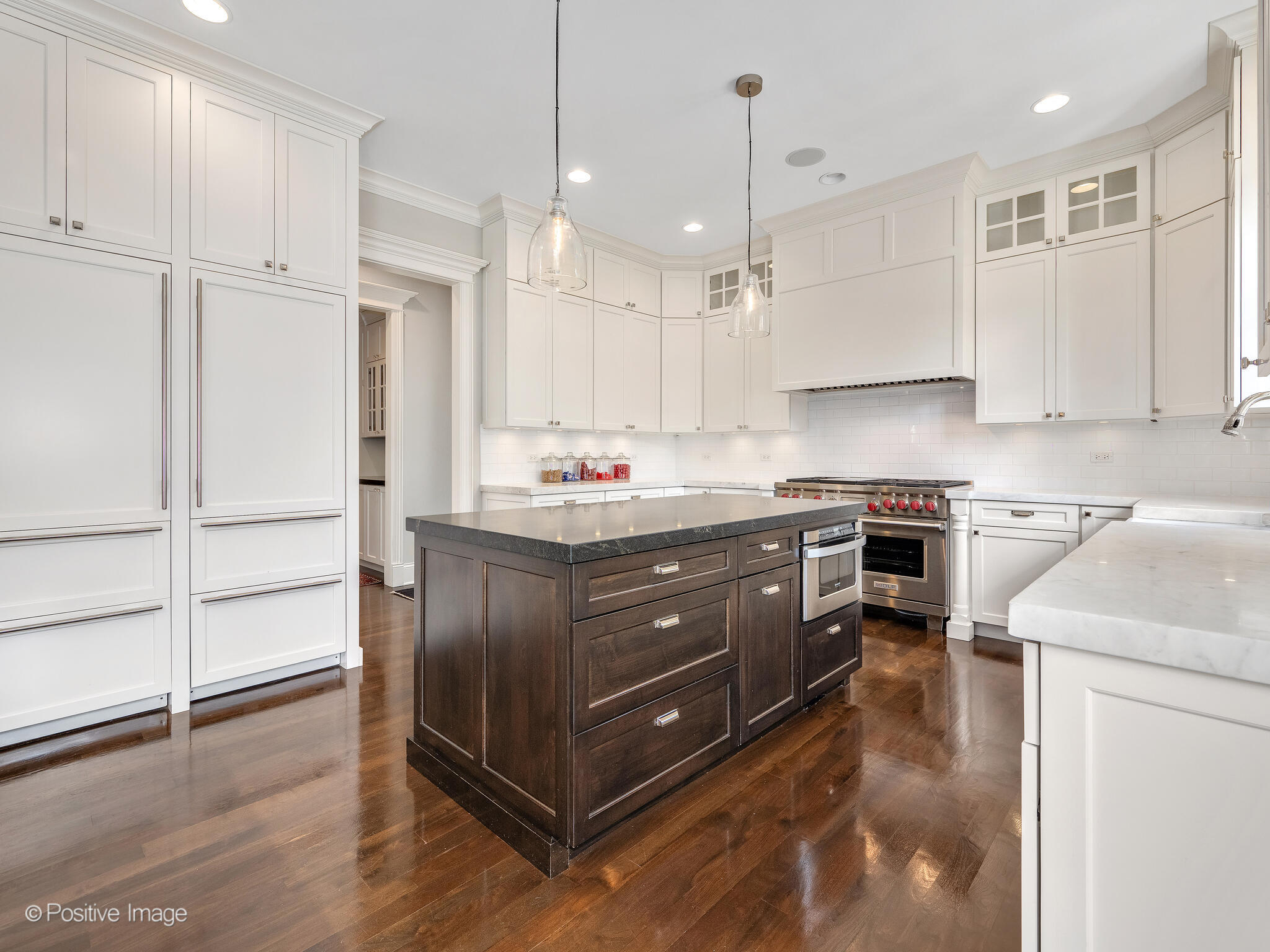 17 South Bruner Street Hinsdale, IL 60521 - Photo 16 of 42 a kitchen with kitchen island granite countertop wooden cabinets and white appliances