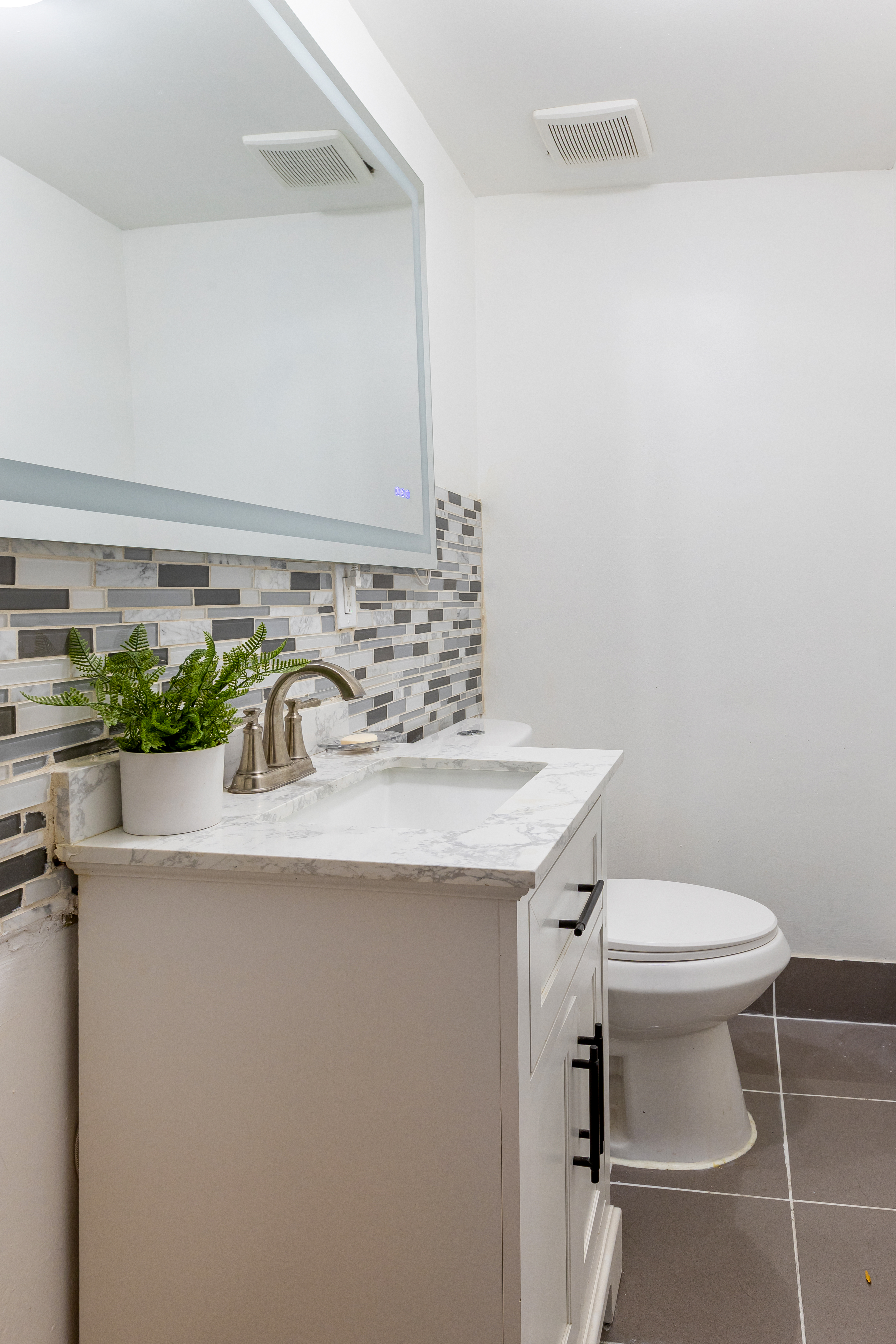 610 East 181st Street Bronx, NY 10457 - Photo 7 of 13 a bathroom with a sink and a toilet