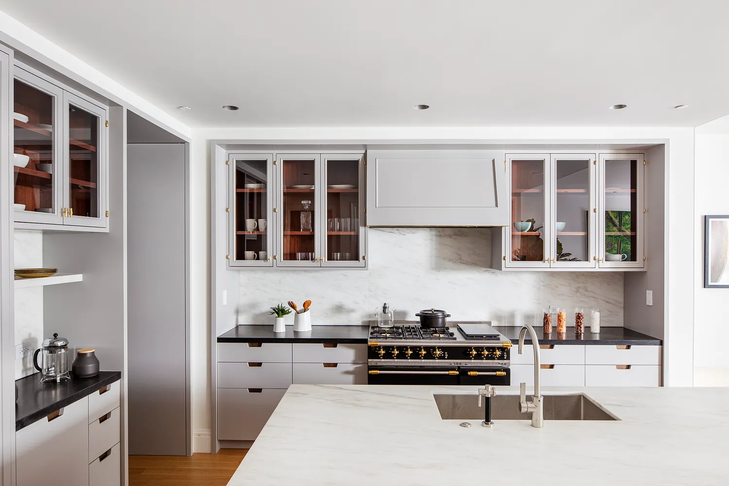 a kitchen with stainless steel appliances kitchen island granite countertop a stove and cabinets