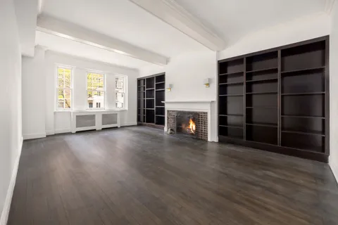 wooden floor in an empty room with a fireplace