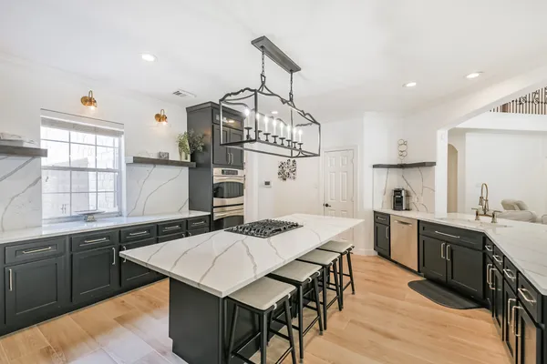 a kitchen that has a table and chairs in it