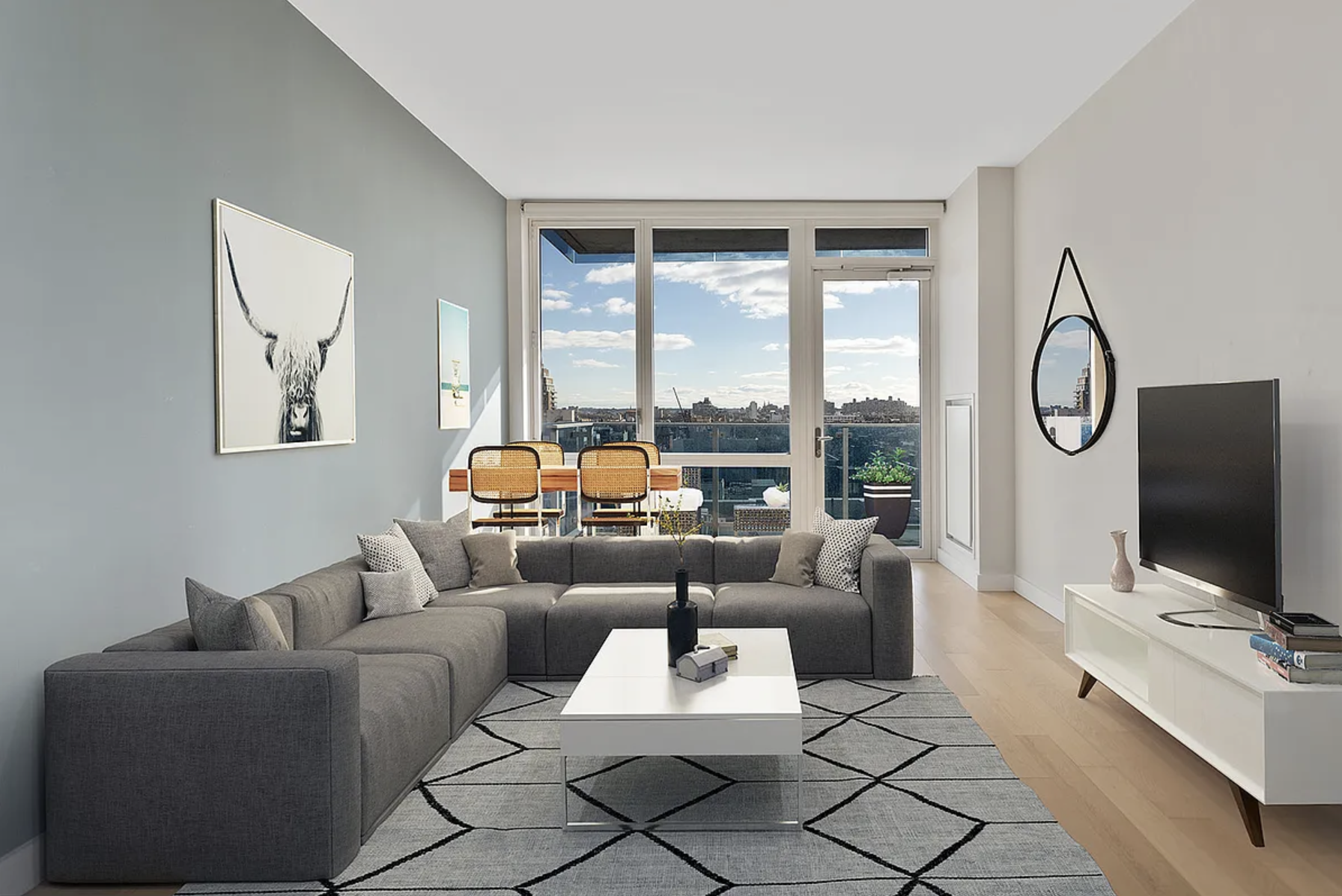 a living room with furniture a flat screen tv and a large window