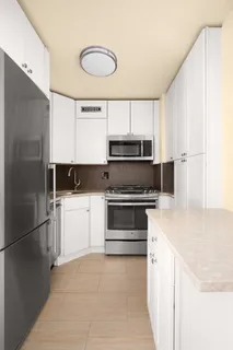 a kitchen with a refrigerator stove and microwave