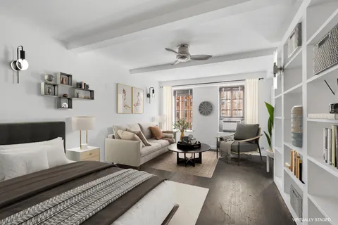 a living room with furniture or couch and a bookshelf