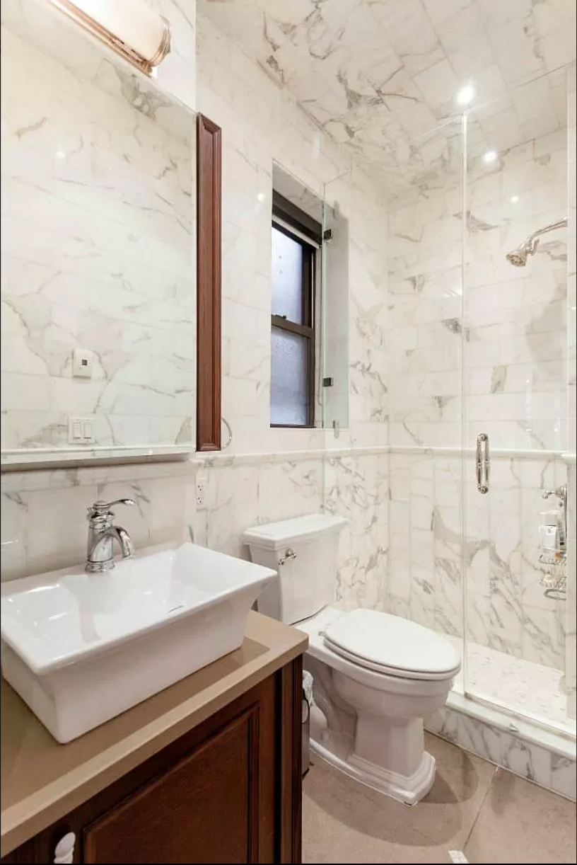 80 Charles Street, Unit 2R Manhattan, NY 10014 - Photo 4 of 5 a bathroom with a sink toilet and shower