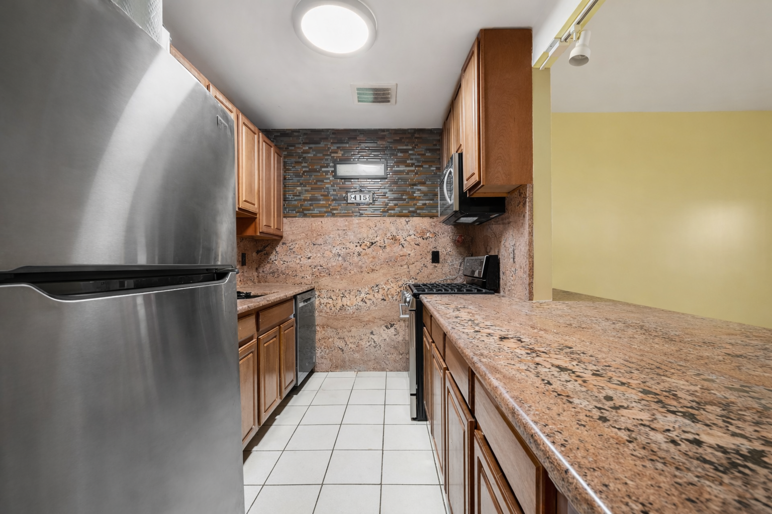 415 East 160th Street, Unit 1 Bronx, NY 10451 - Photo 12 of 16 a kitchen with a sink stove and refrigerator