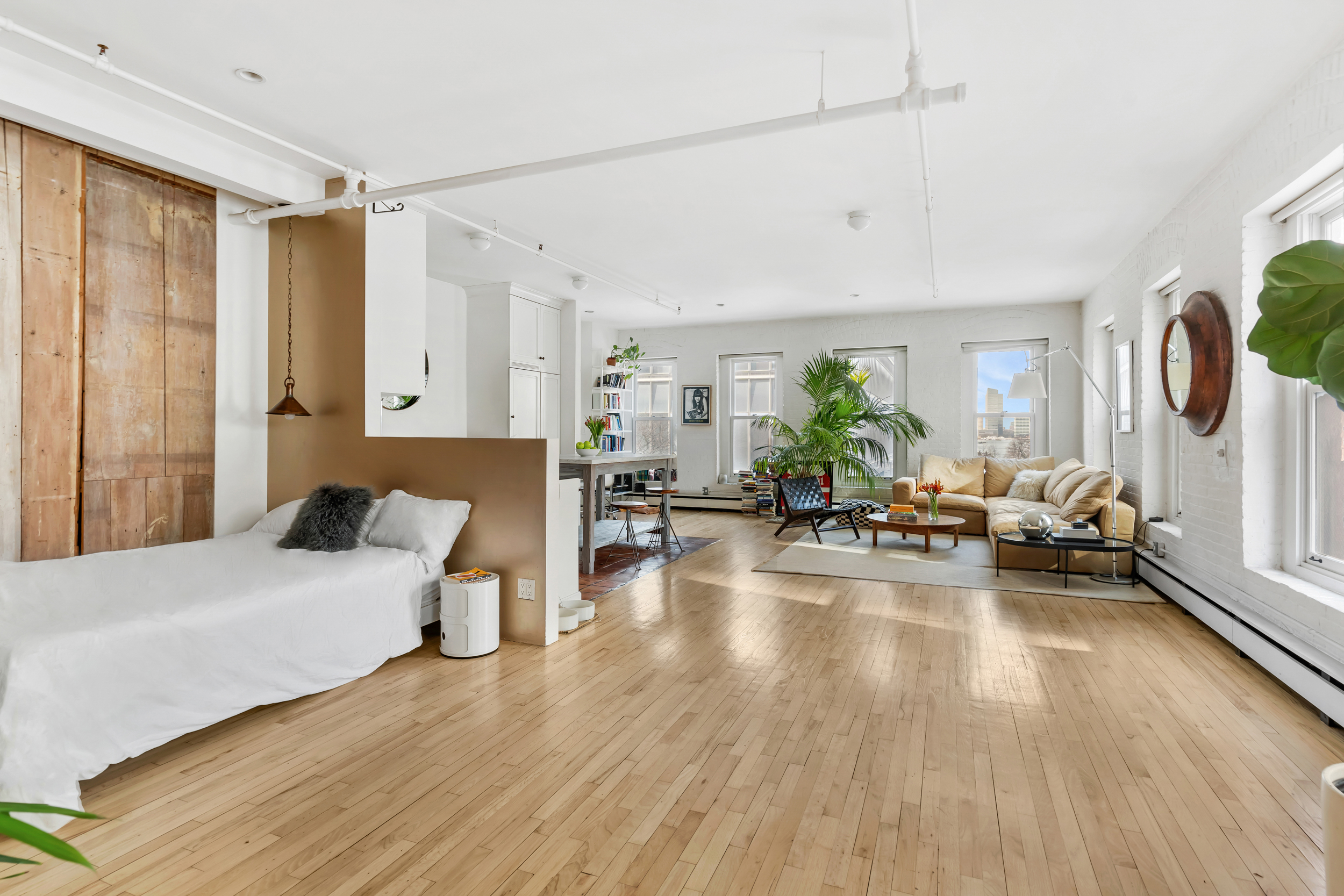 19 Hubert Street, Unit 3 Manhattan, NY 10013 - Photo 5 of 8 a living room with furniture and a wooden floor