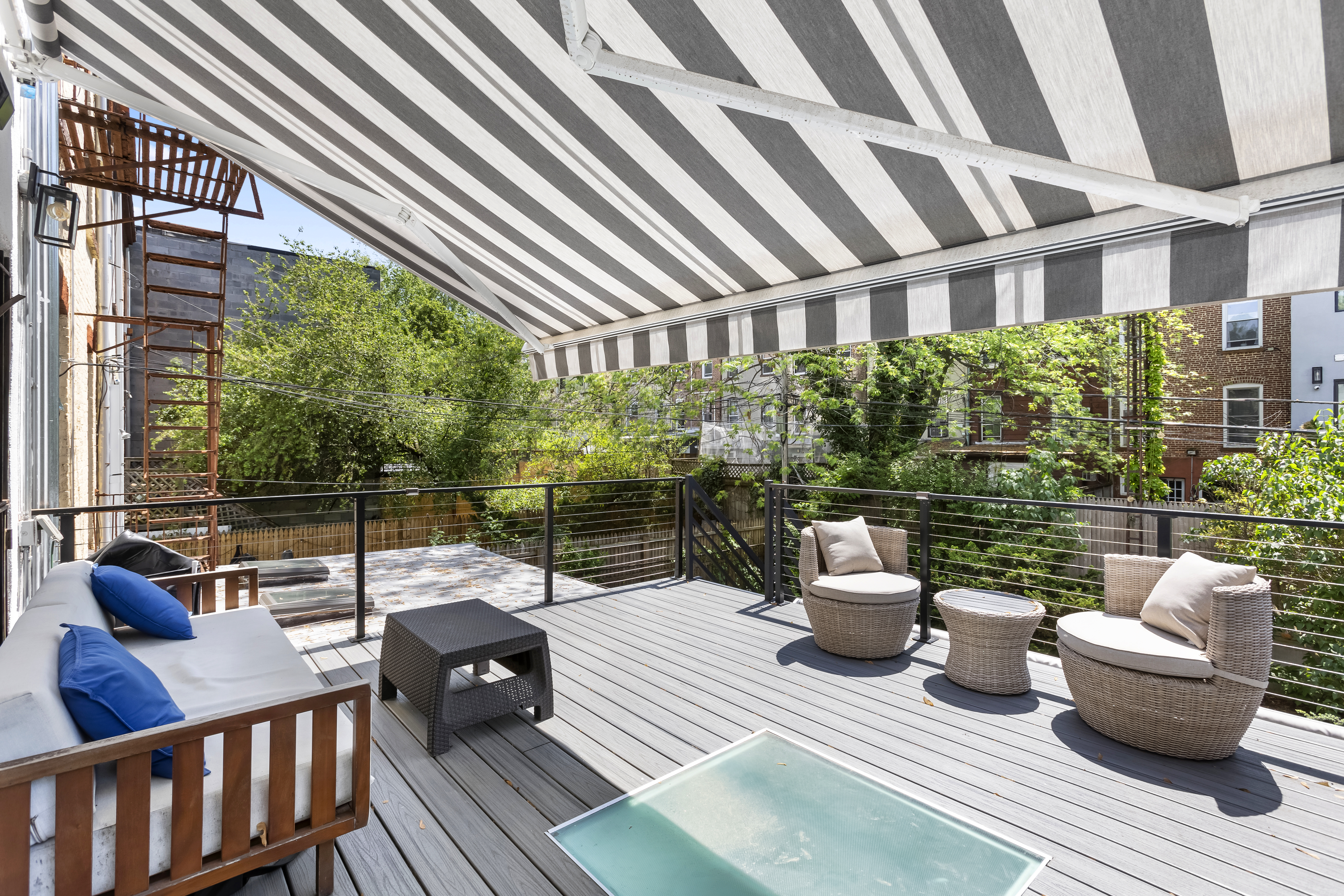 312 10th Street Brooklyn, NY 11215 - Photo 14 of 17 a view of a patio with couches chairs dining table and chairs with wooden floor