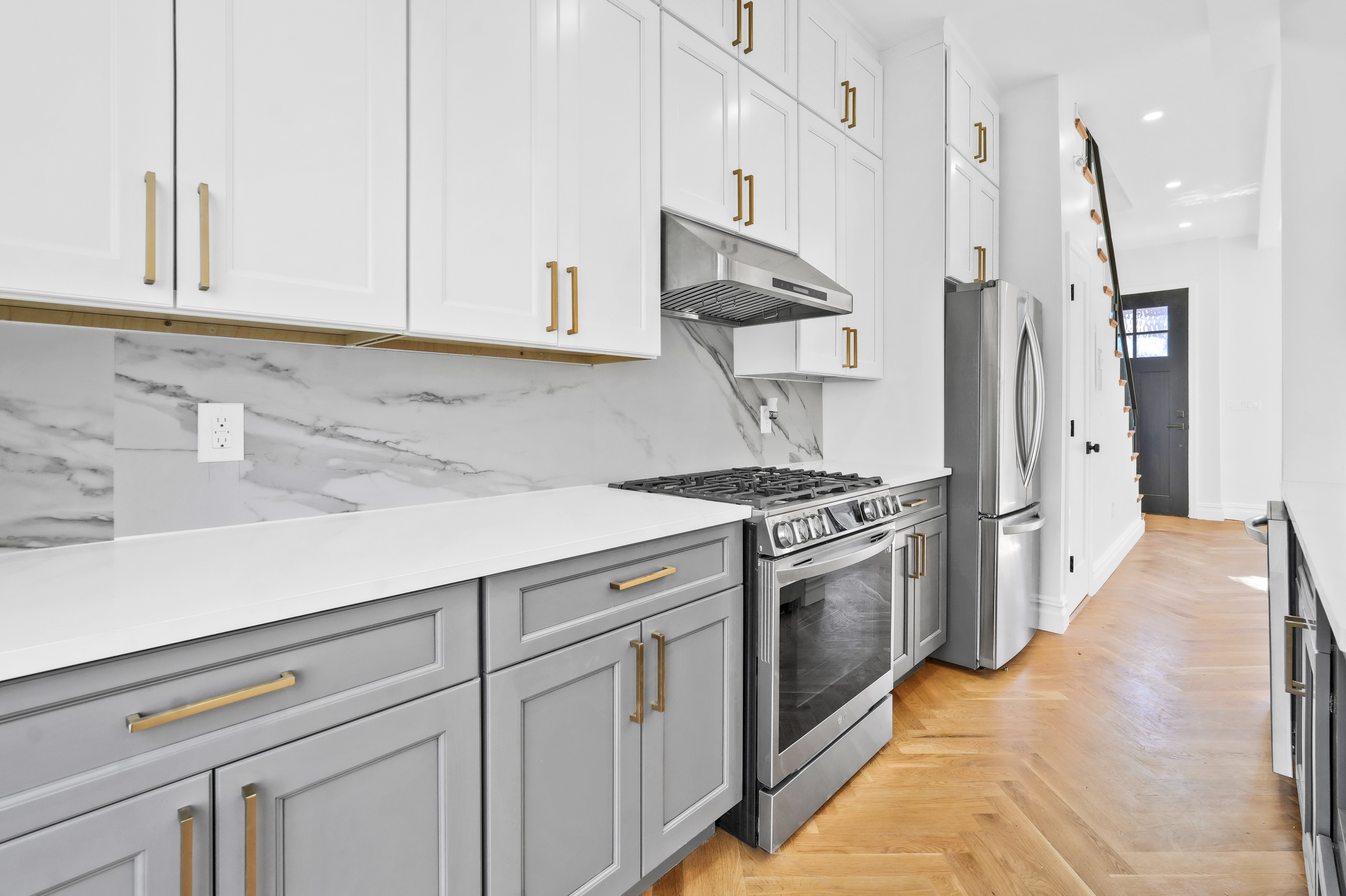 473 Monroe Street Brooklyn, NY 11221 - Photo 8 of 40 a kitchen with stainless steel appliances white cabinets and a sink