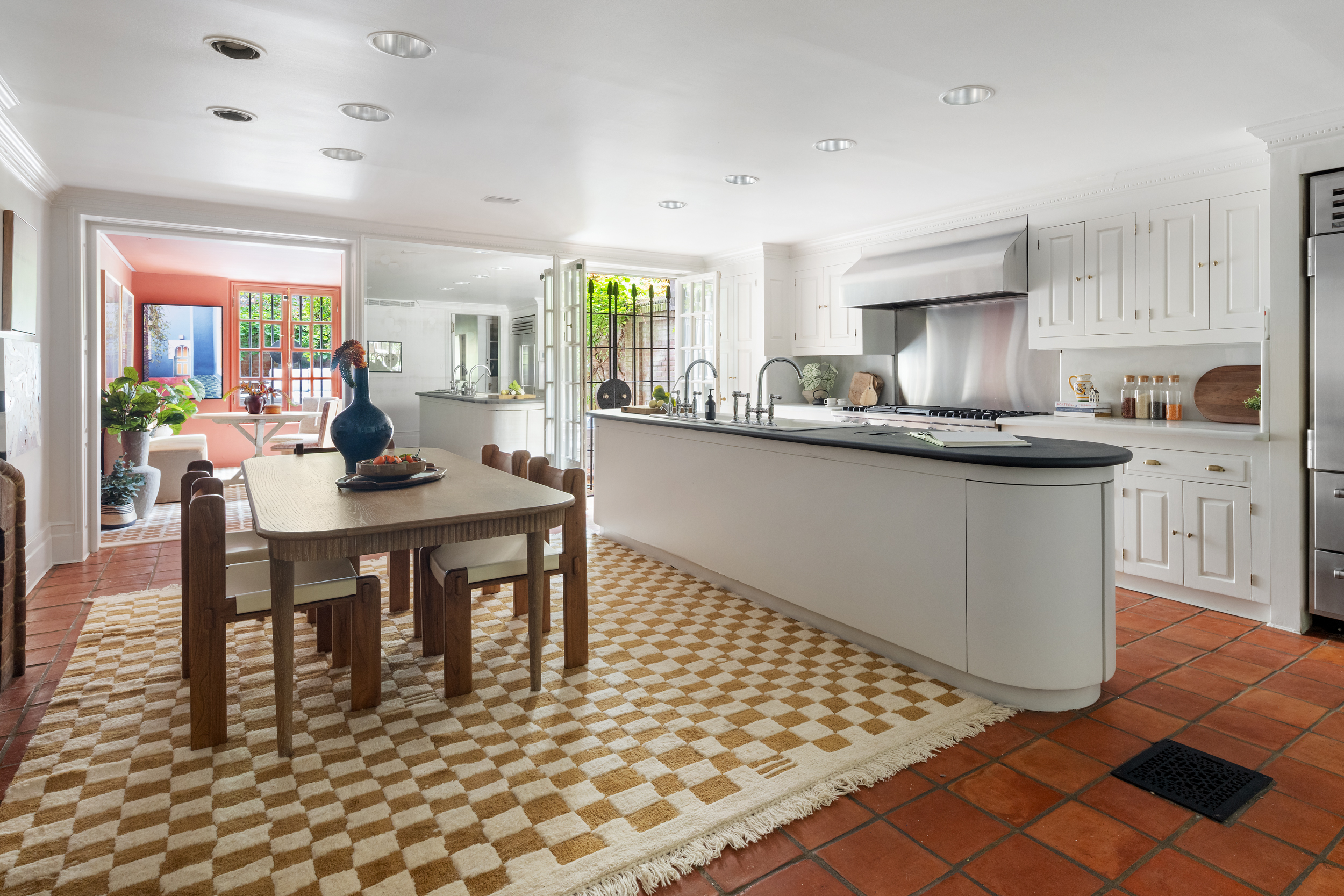 37 West 70th Street Manhattan, NY 10023 - Photo 15 of 41 a kitchen with stainless steel appliances granite countertop a sink a stove a dining table and chairs