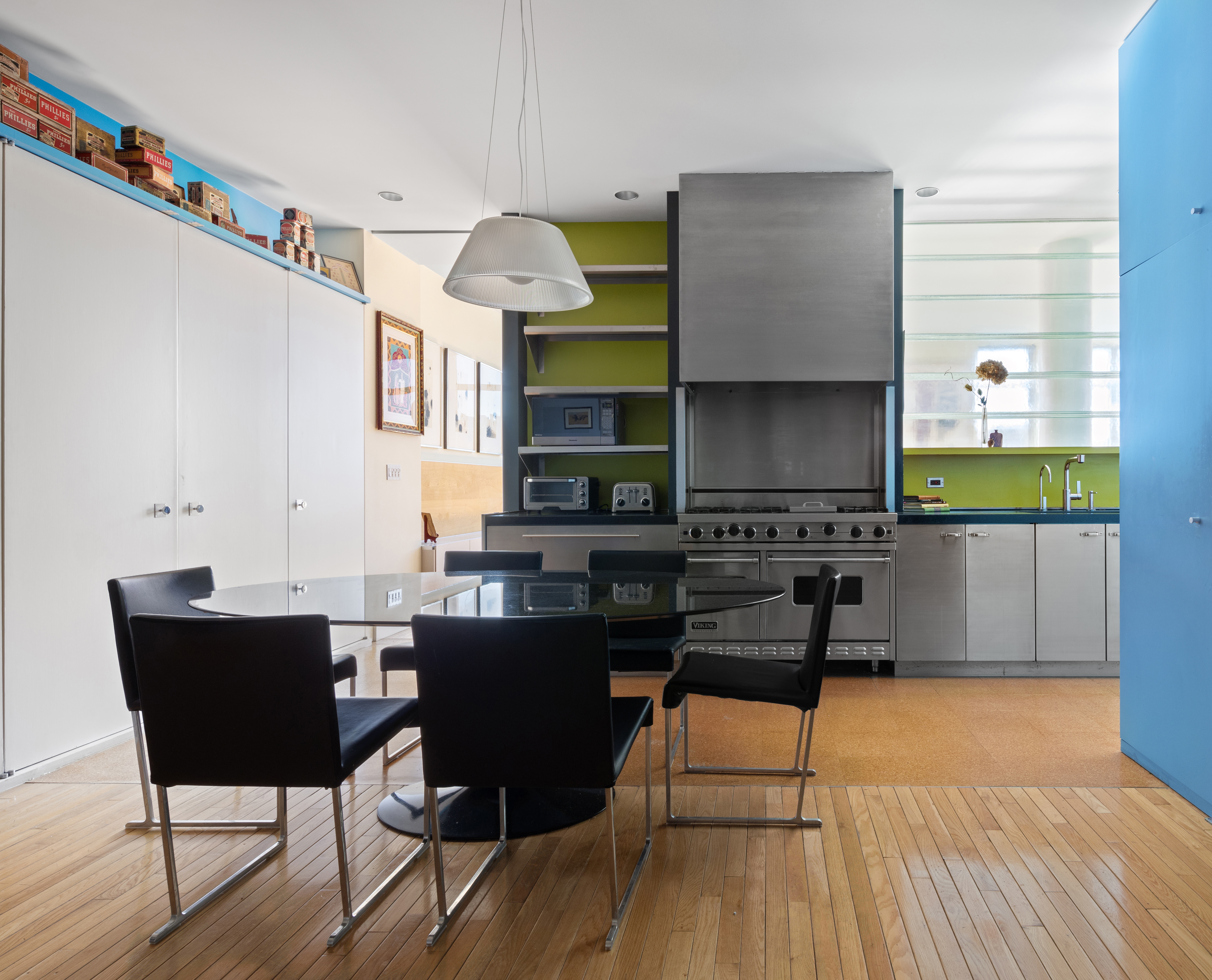 252 7th Avenue, Unit 9X Manhattan, NY 10001 - Photo 7 of 26 a kitchen with a table chairs and a wooden floor