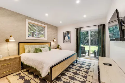 a bedroom with a large bed and a large window
