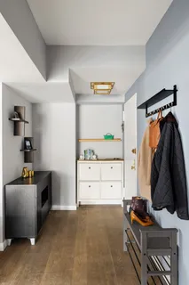 a bedroom with a window and dresser