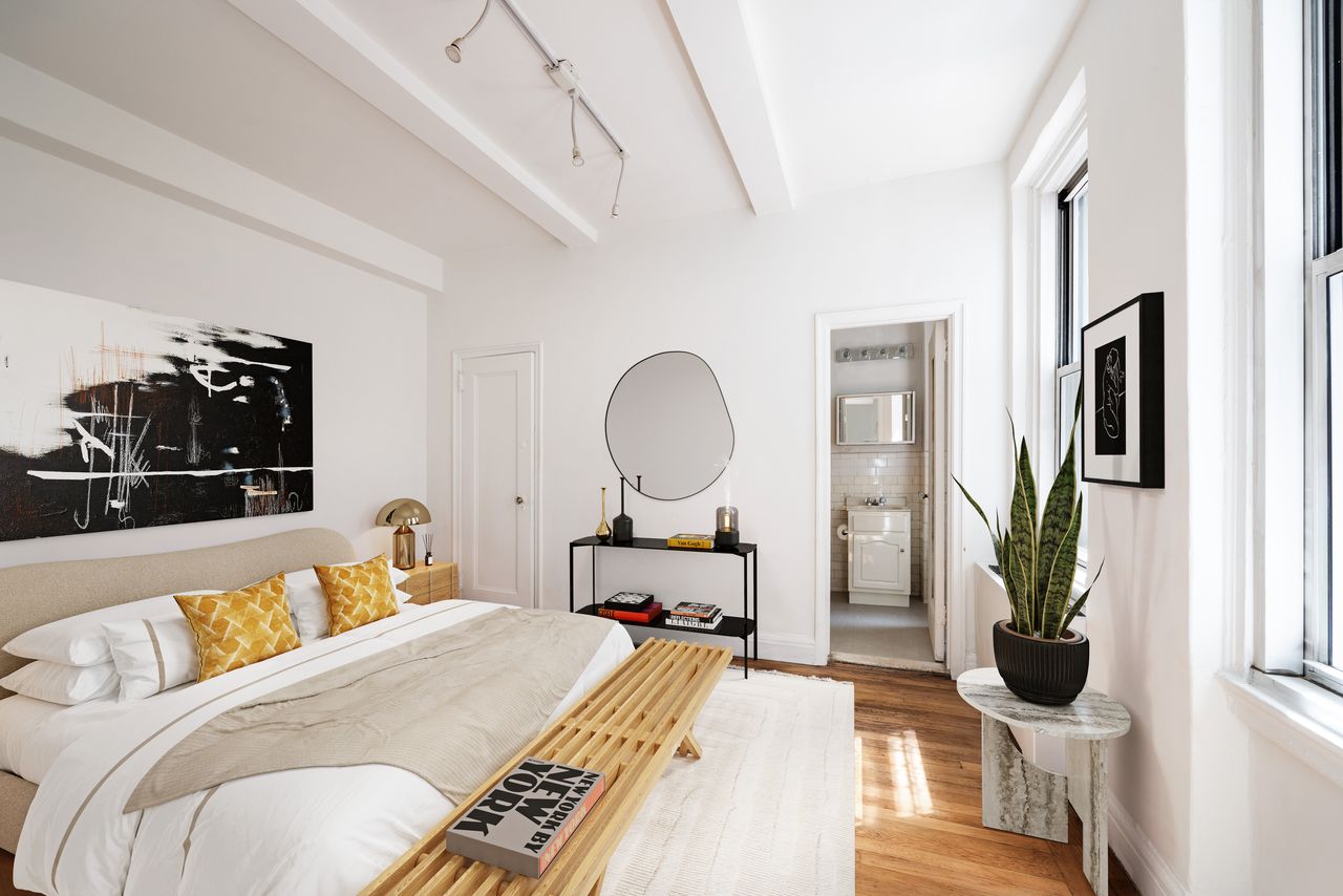 325 West 45th Street, Unit 108 Manhattan, NY 10036 - Photo 4 of 12 a bed room with a bed and a potted plant