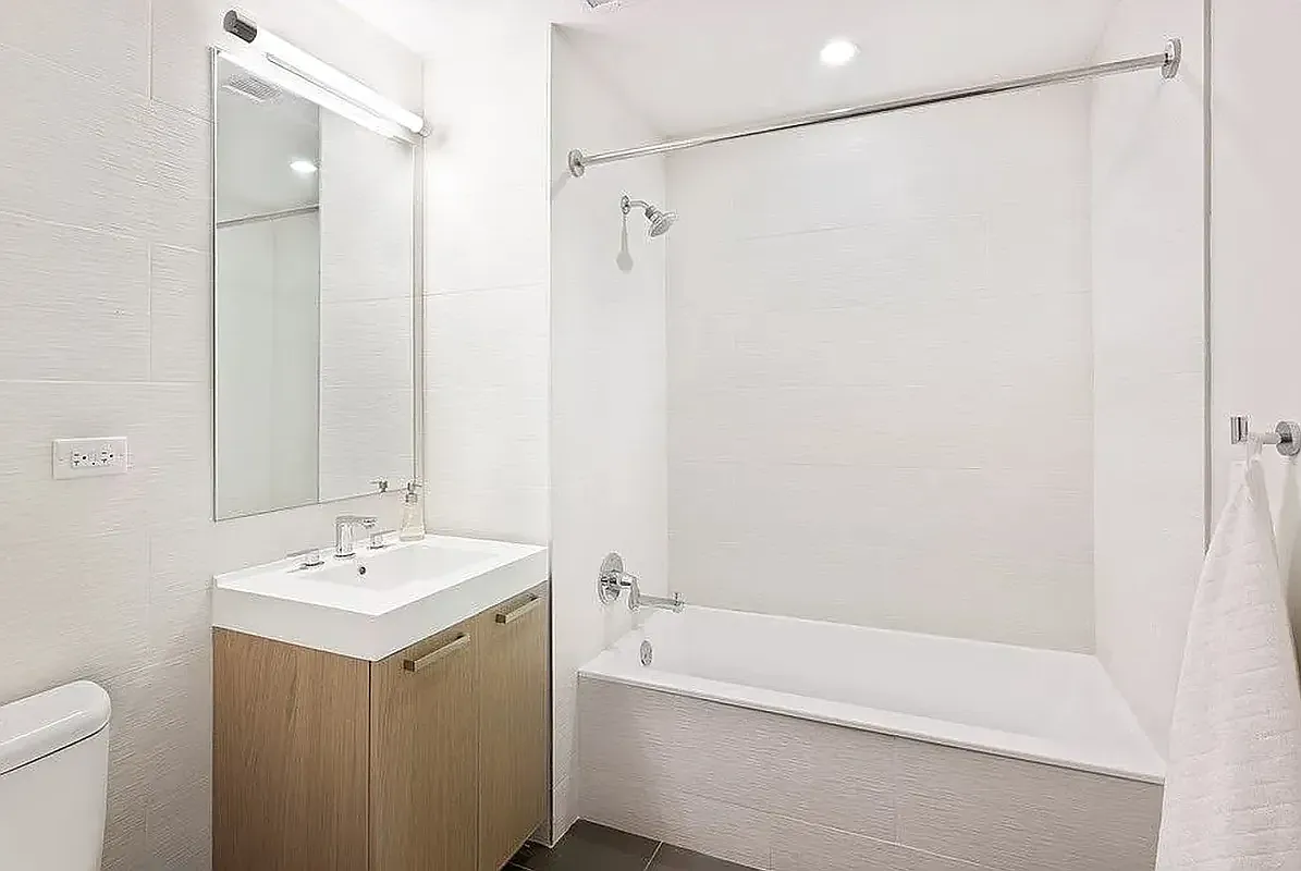 26-14 Jackson Avenue, Unit PHD Queens, NY 11101 - Photo 3 of 11 a bathroom with a bathtub a sink and a shower