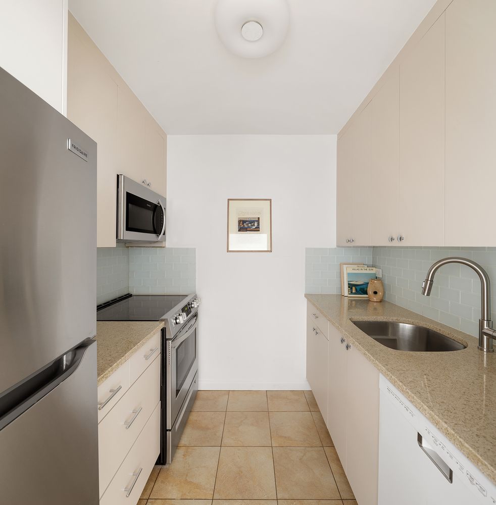 a kitchen with a sink and a stove top oven