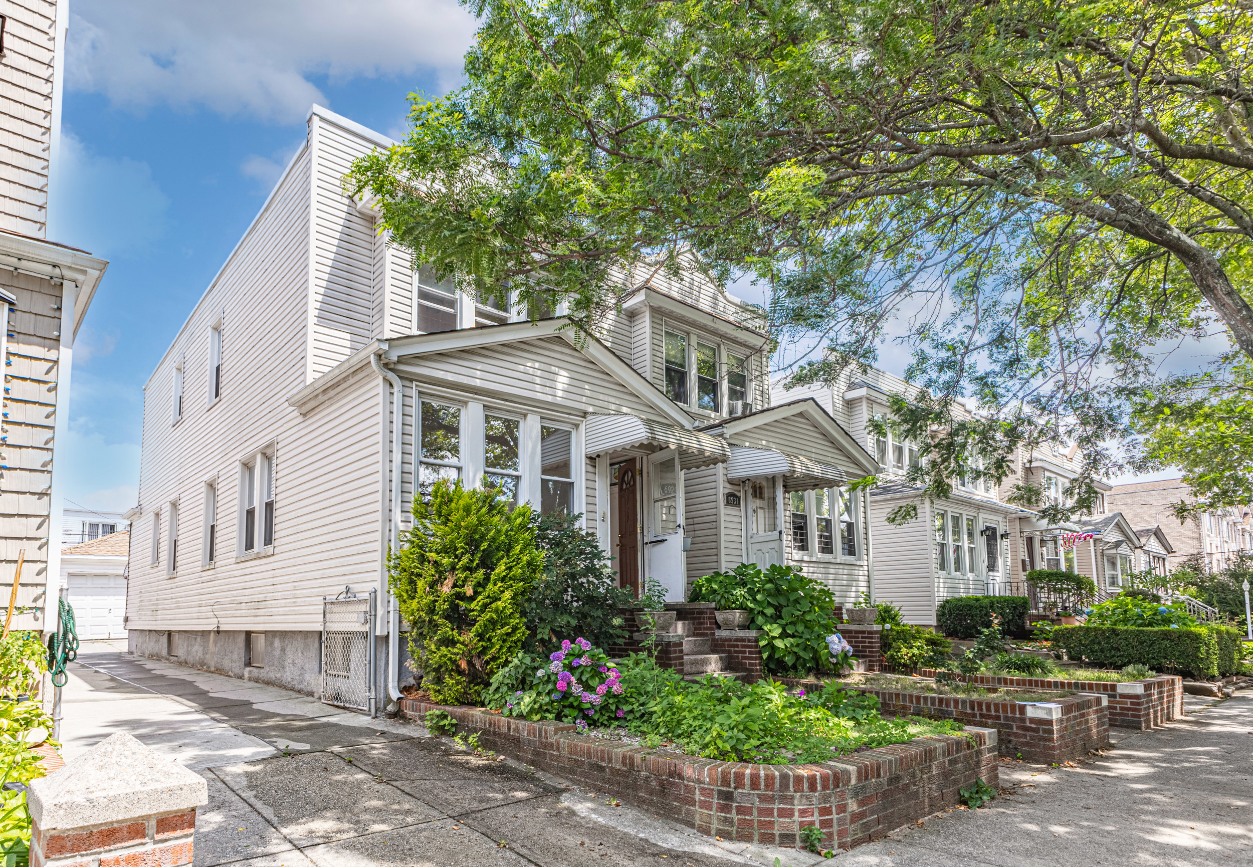 a front view of a house with a garden