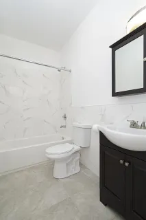 a bathroom with a sink a toilet and a bathtub