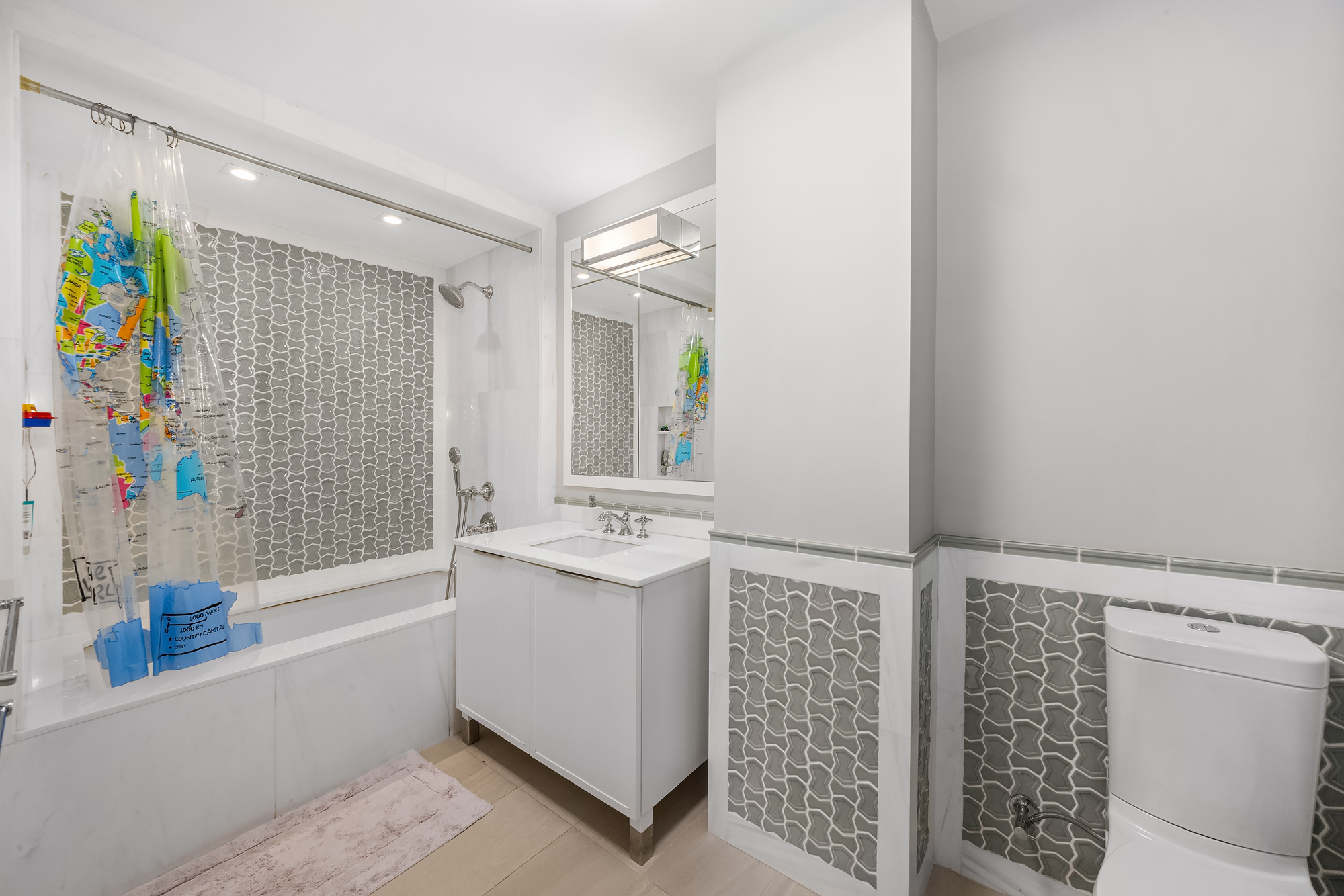 344 West 72nd Street, Unit 1007 Manhattan, NY 10023 - Photo 14 of 23 a bathroom with a bathtub sink and mirror