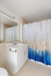 a bathroom with a sink a toilet and a shower