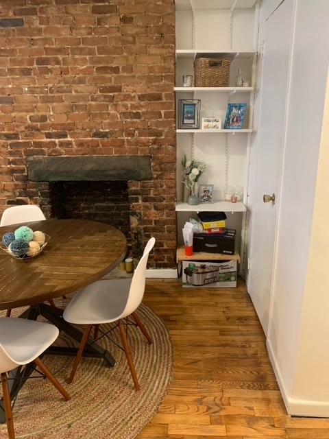 143 Sullivan Street, Unit 12 Manhattan, NY 10012 - Photo 8 of 11 a living room with a table and chairs