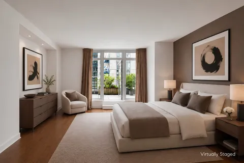 a bedroom with bed couch and window