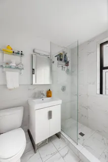 a white toilet sitting next to a bathroom sink