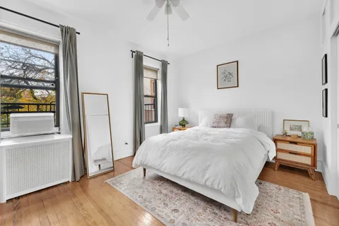 a bedroom with a large bed and a window