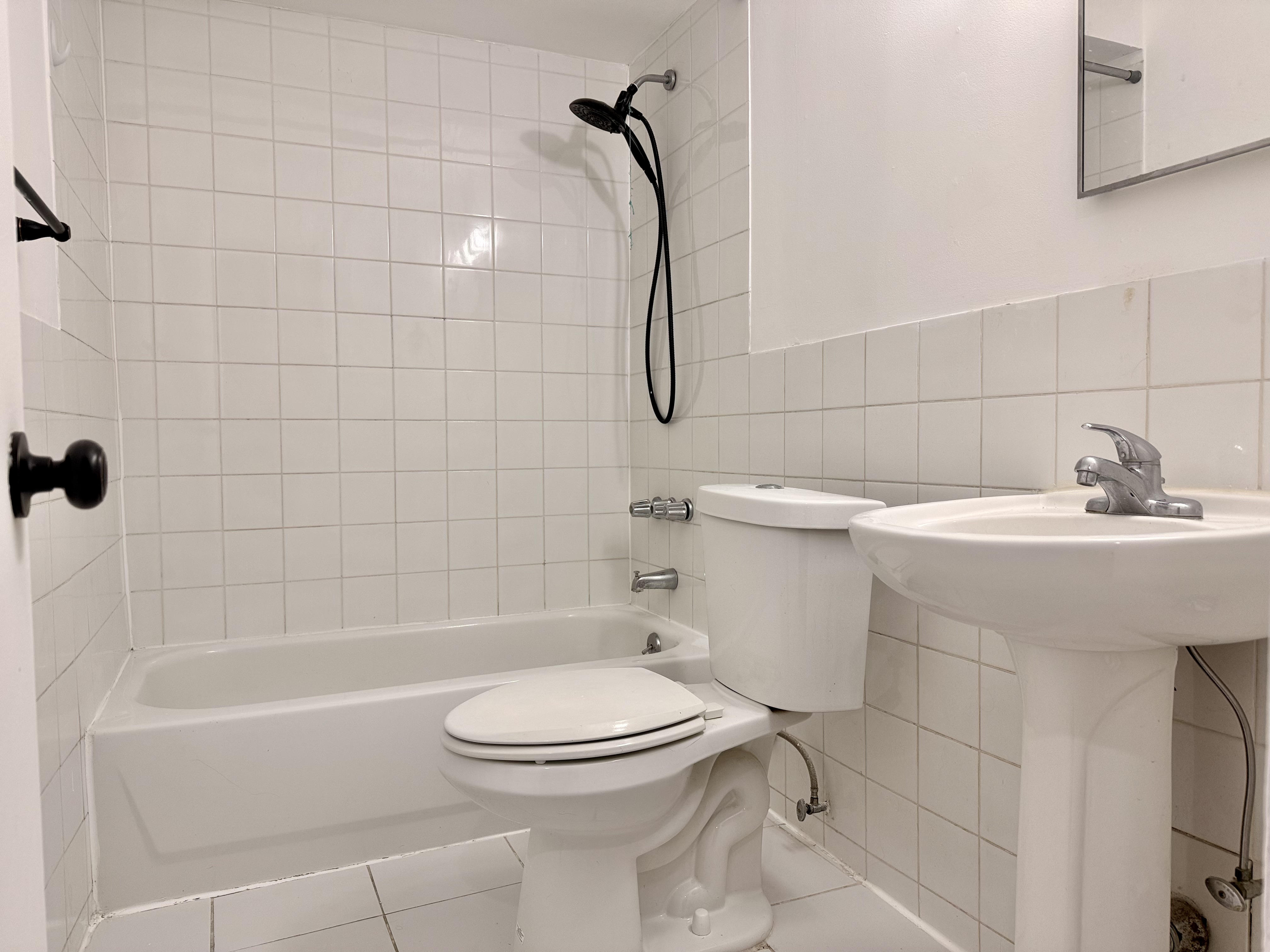 1997 3rd Avenue, Unit 1A Manhattan, NY 10029 - Photo 11 of 23 a bathroom with a sink a toilet and shower