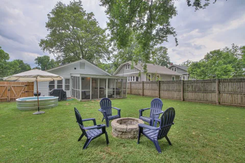 a view of a backyard with furniture and a garden