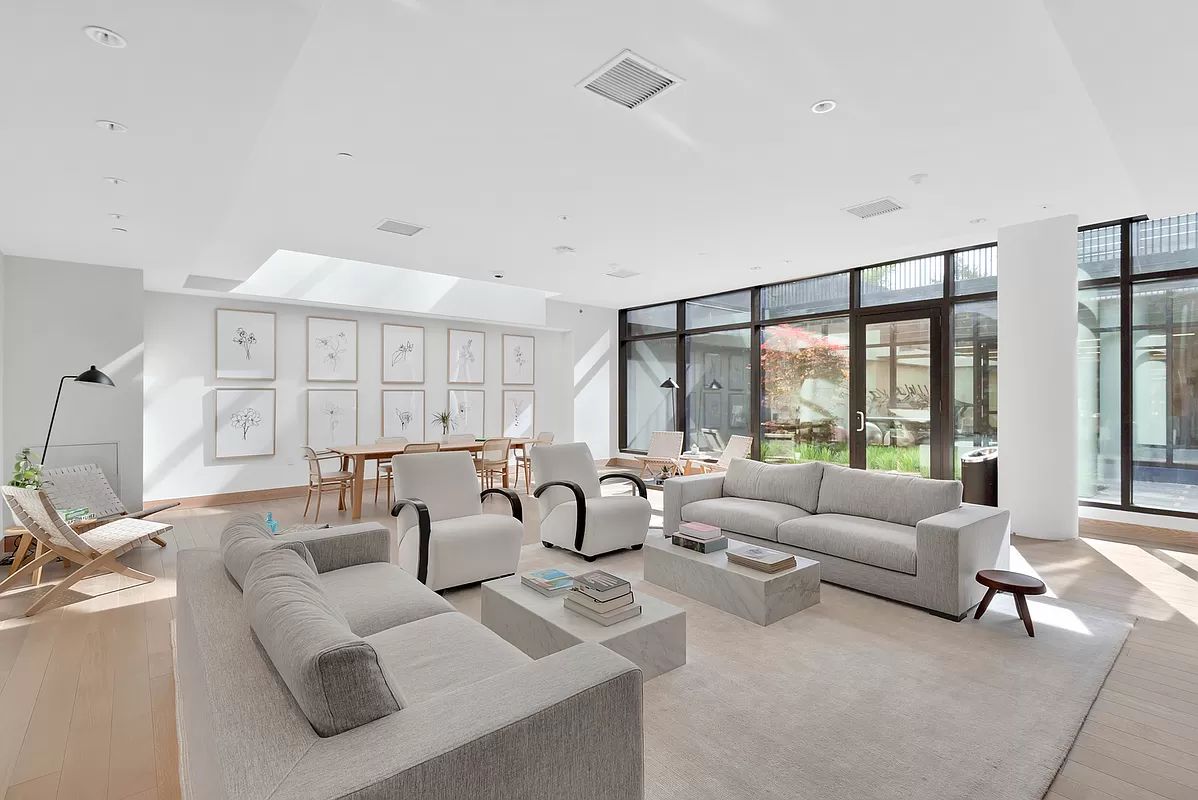 21-30 44th Drive, Unit 7D Queens, NY 11101 - Photo 10 of 14 a living room with furniture and a large window