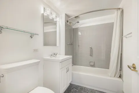 a bathroom with a sink mirror toilet and bathtub