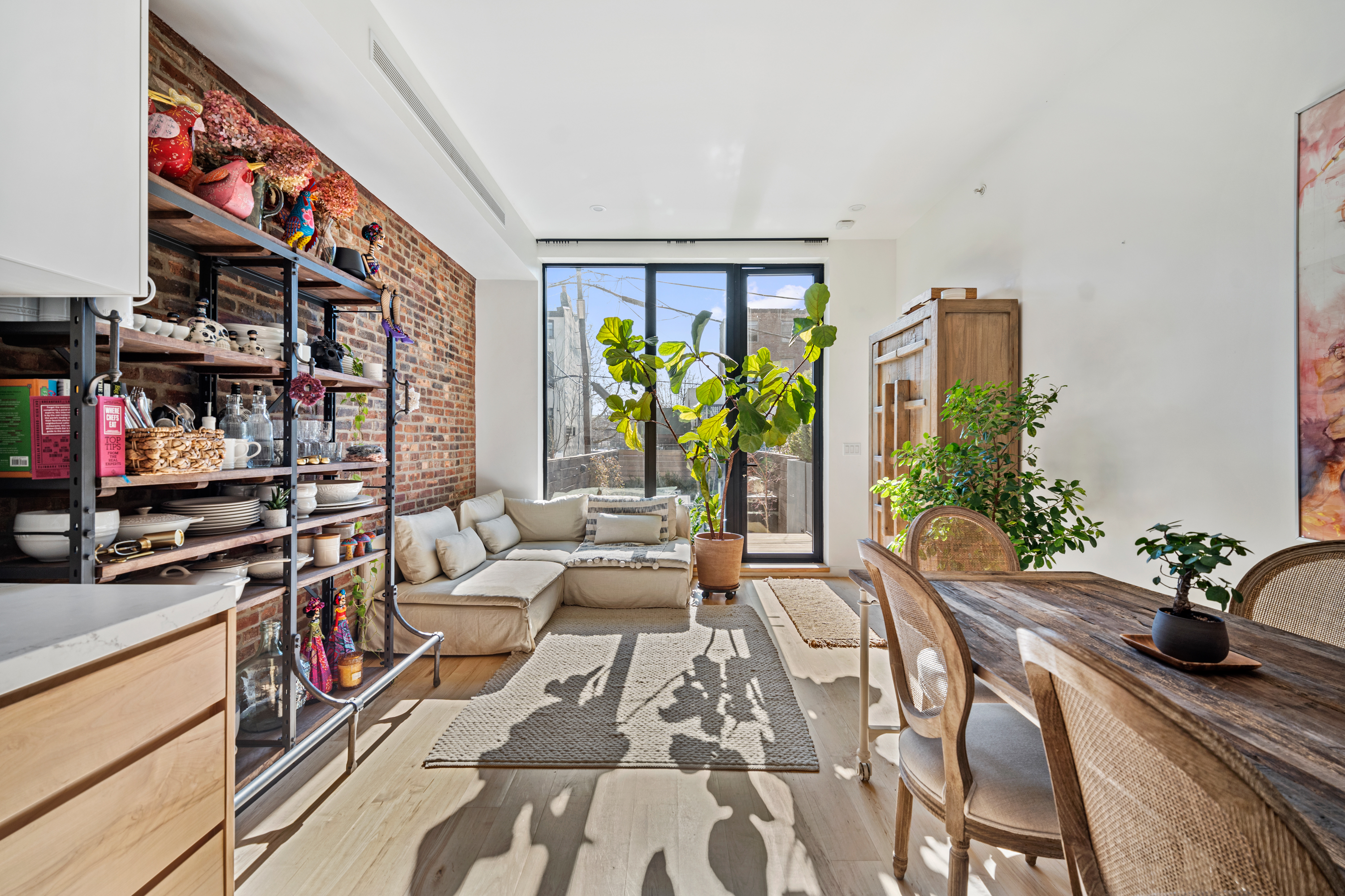a living room with furniture stove and potted plant