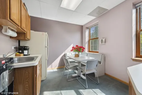 a view of a dining room with furniture and window