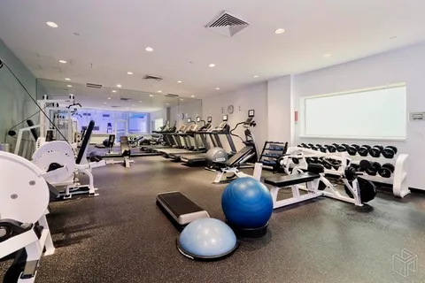 a room with gym equipment and lots of equipment