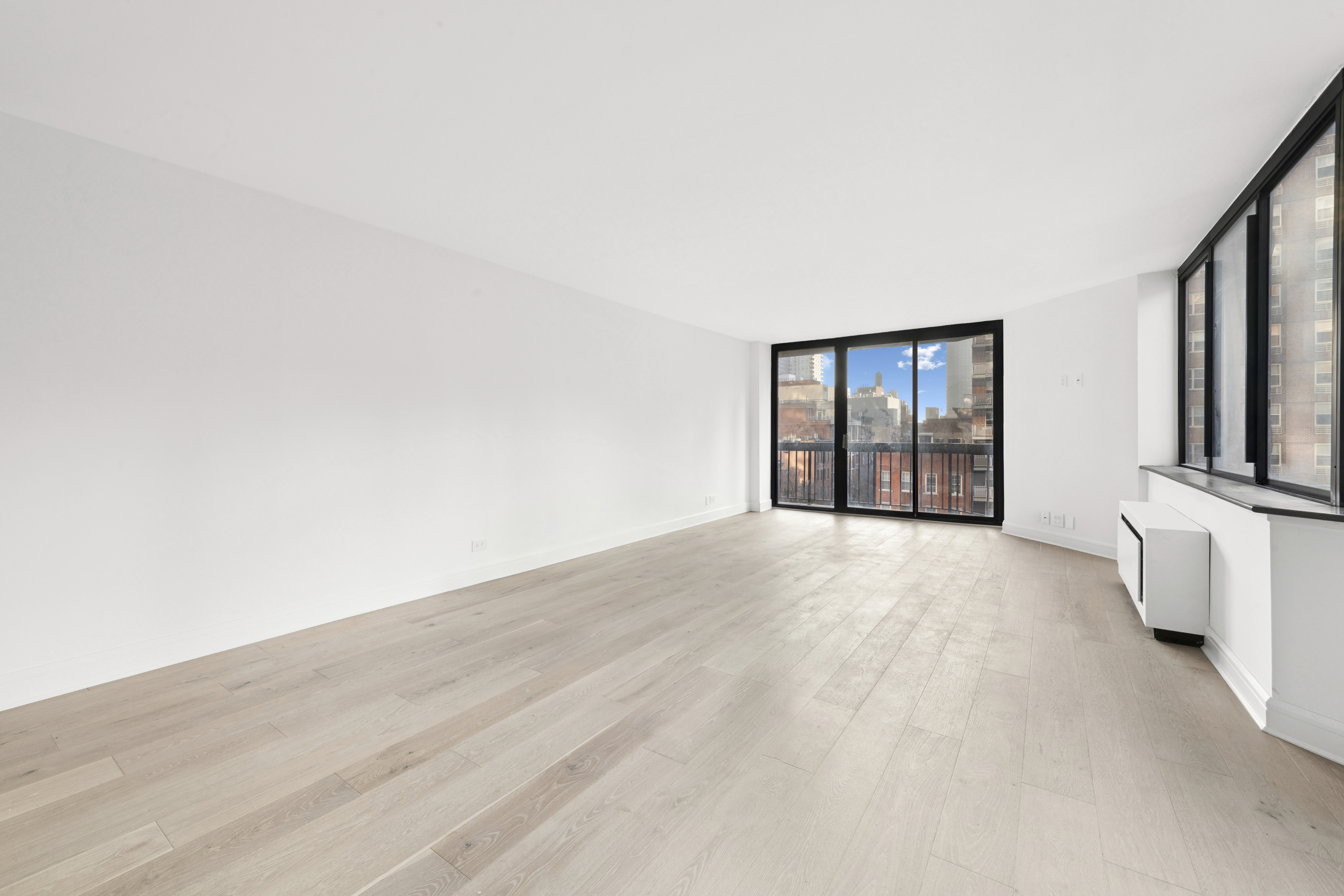 330 East 75th Street, Unit 5B Manhattan, NY 10021 - Photo 4 of 11 a view of an empty room with a fireplace