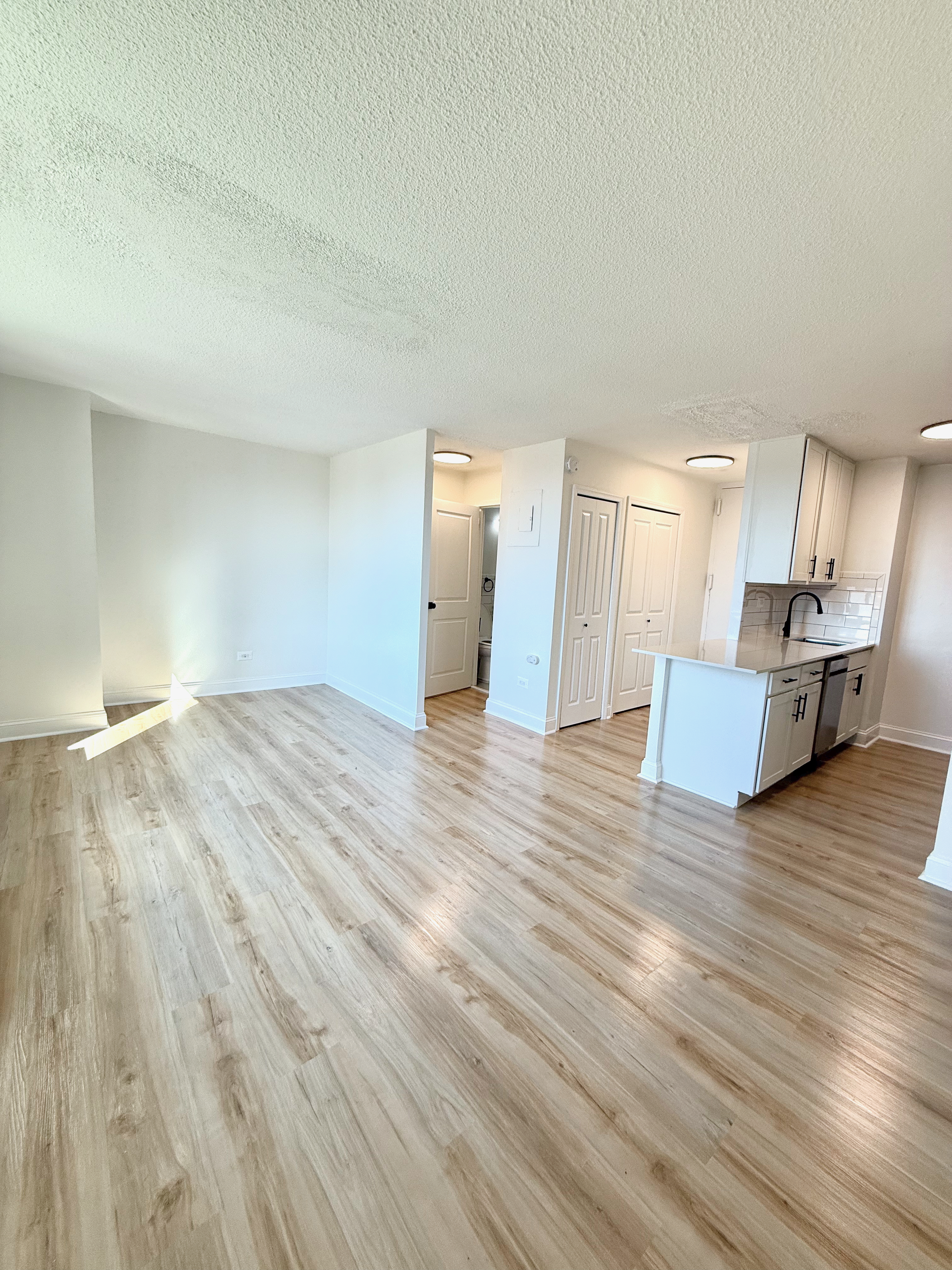 3333 Broadway, Unit D8J Manhattan, NY 10031 - Photo 4 of 22 a view of a room with wooden floor and kitchen view