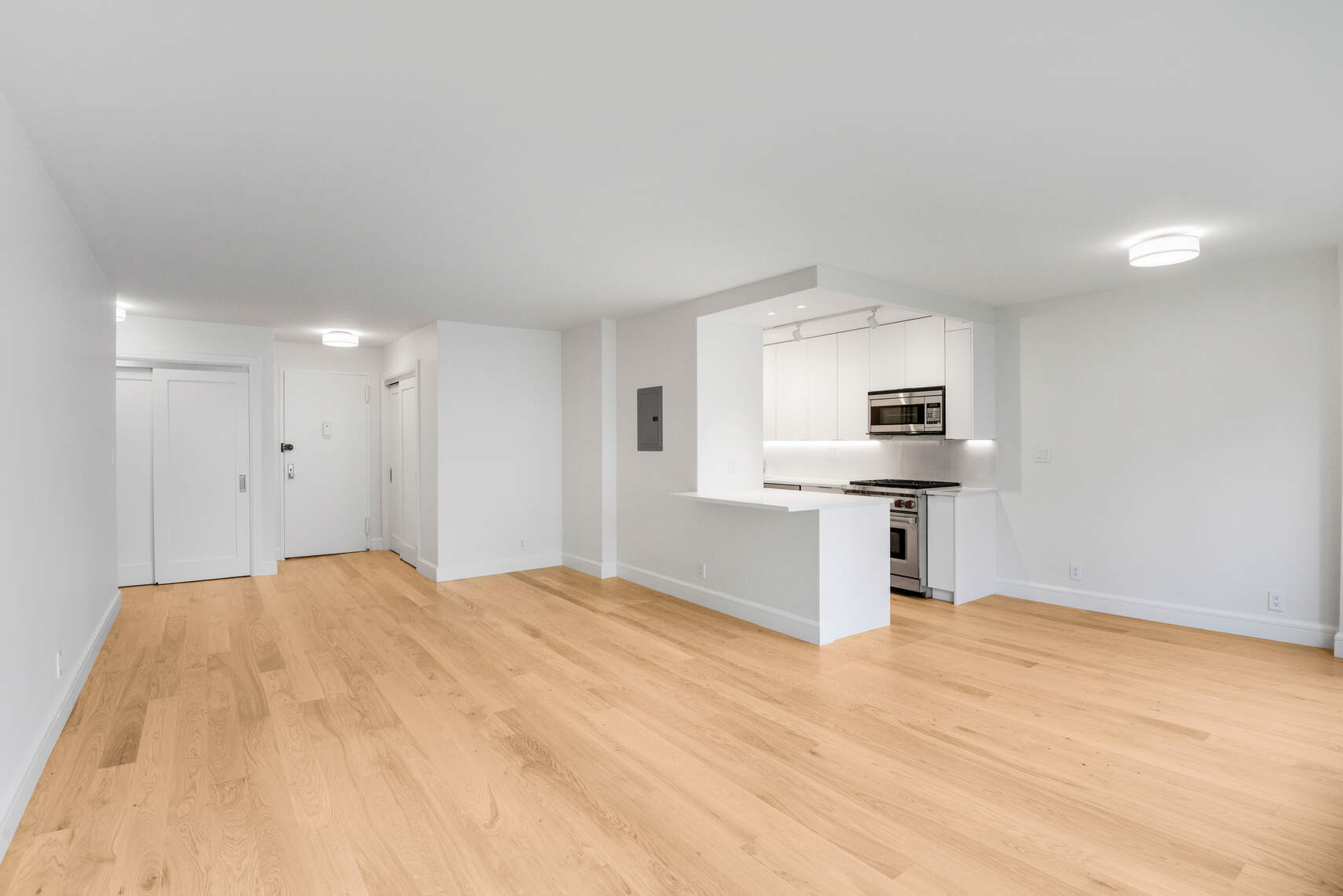 170 West End Avenue, Unit 12B Manhattan, NY 10023 - Photo 4 of 15 a kitchen with stainless steel appliances a refrigerator and a stove