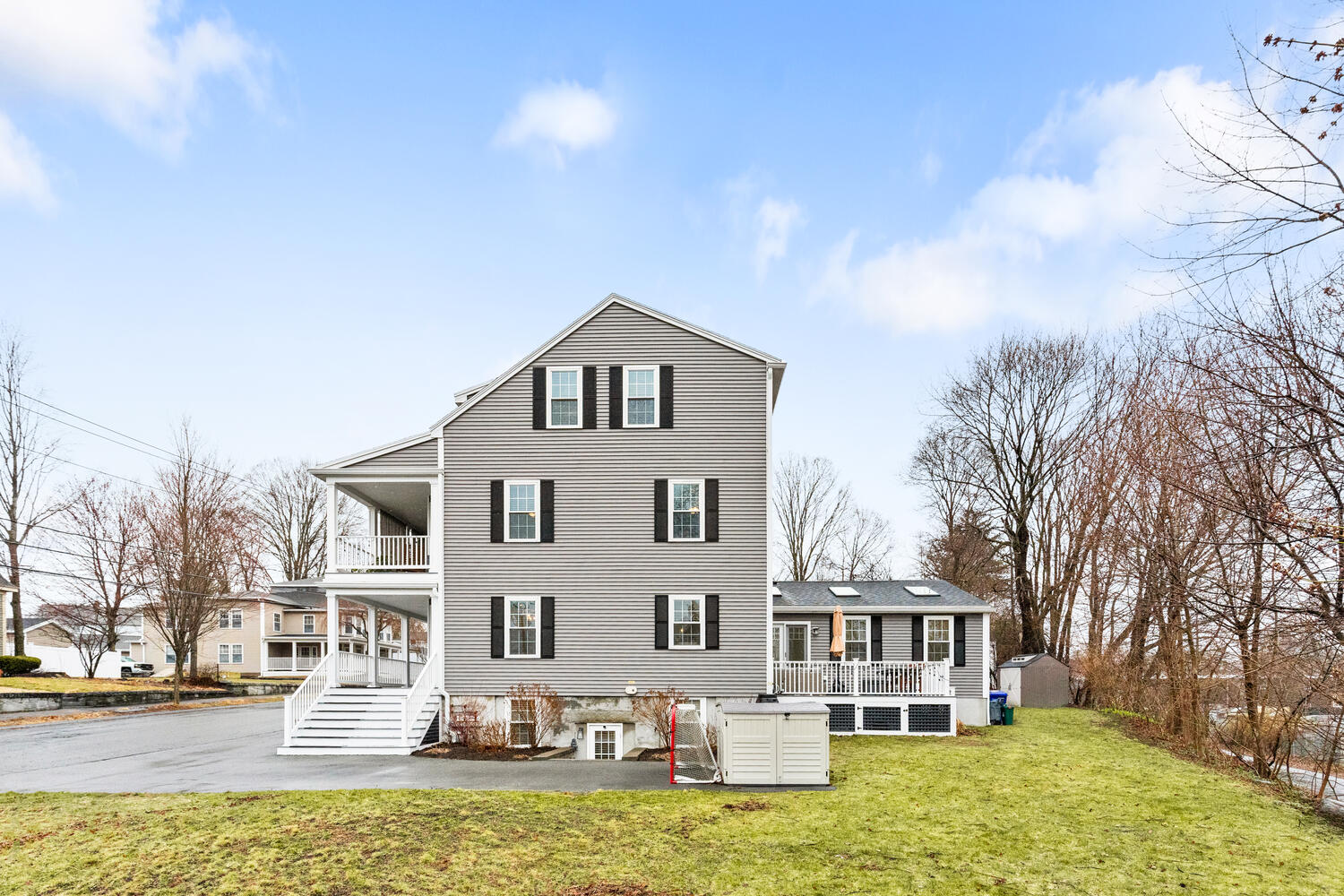 1 Maple Street, Unit 1 Maynard, MA 01754 - Photo 40 of 42 a front view of a building with large garden and trees