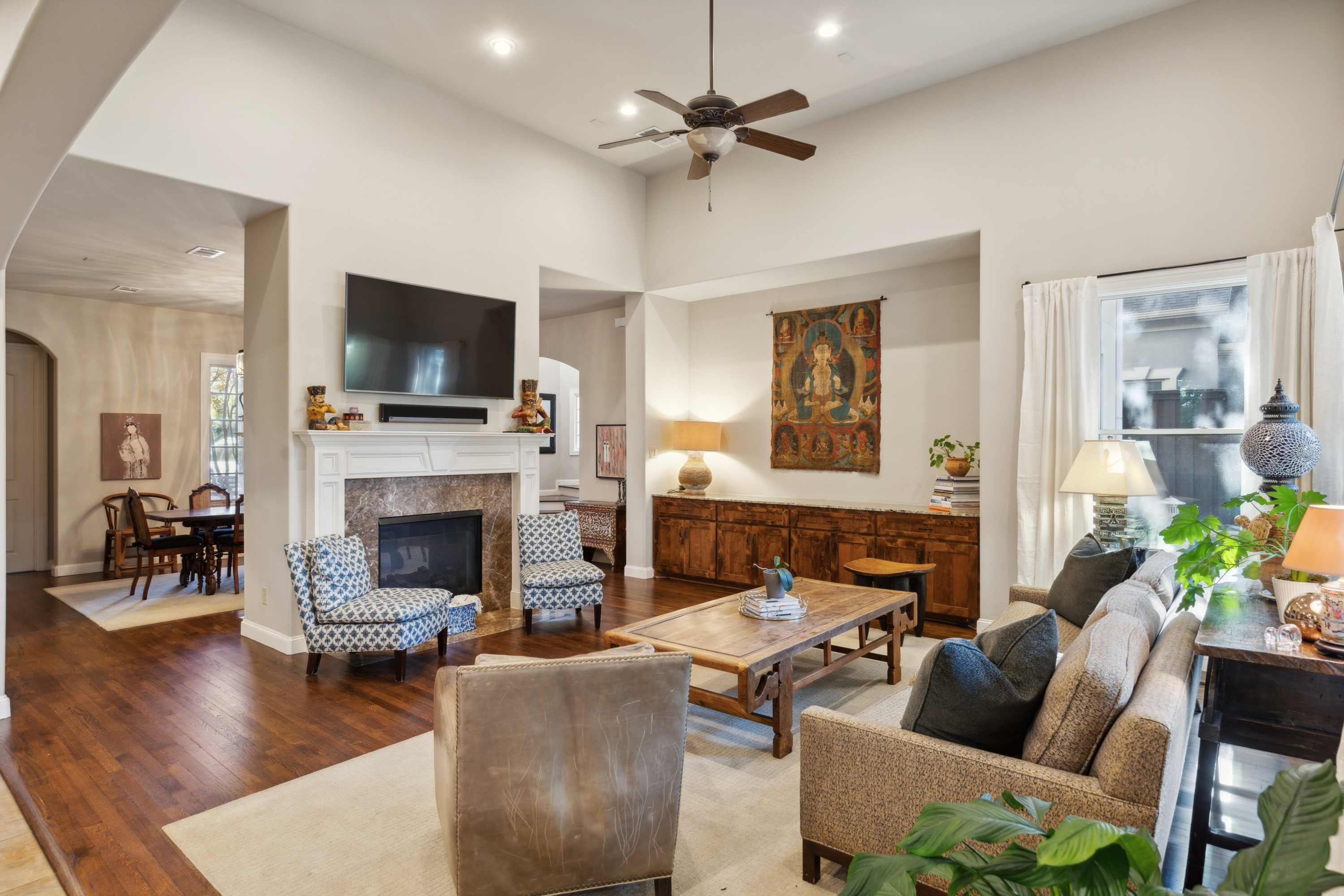 8411 Midway Road Dallas, TX 75209 - Photo 9 of 29 a living room with furniture a fireplace and a flat screen tv