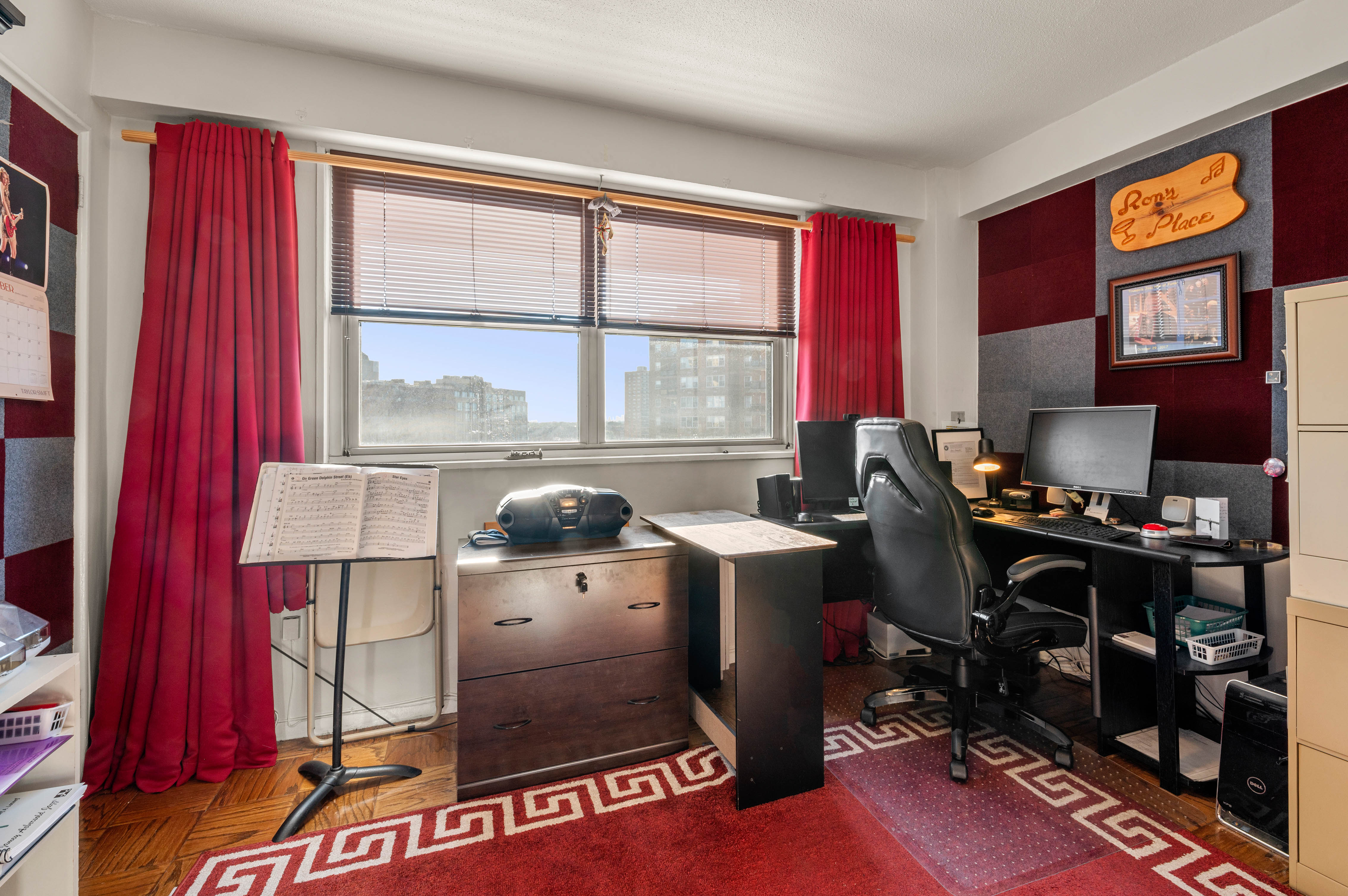 70-31 108th Street, Unit 9C Queens, NY 11375 - Photo 5 of 11 a room with furniture a bookshelf and a window