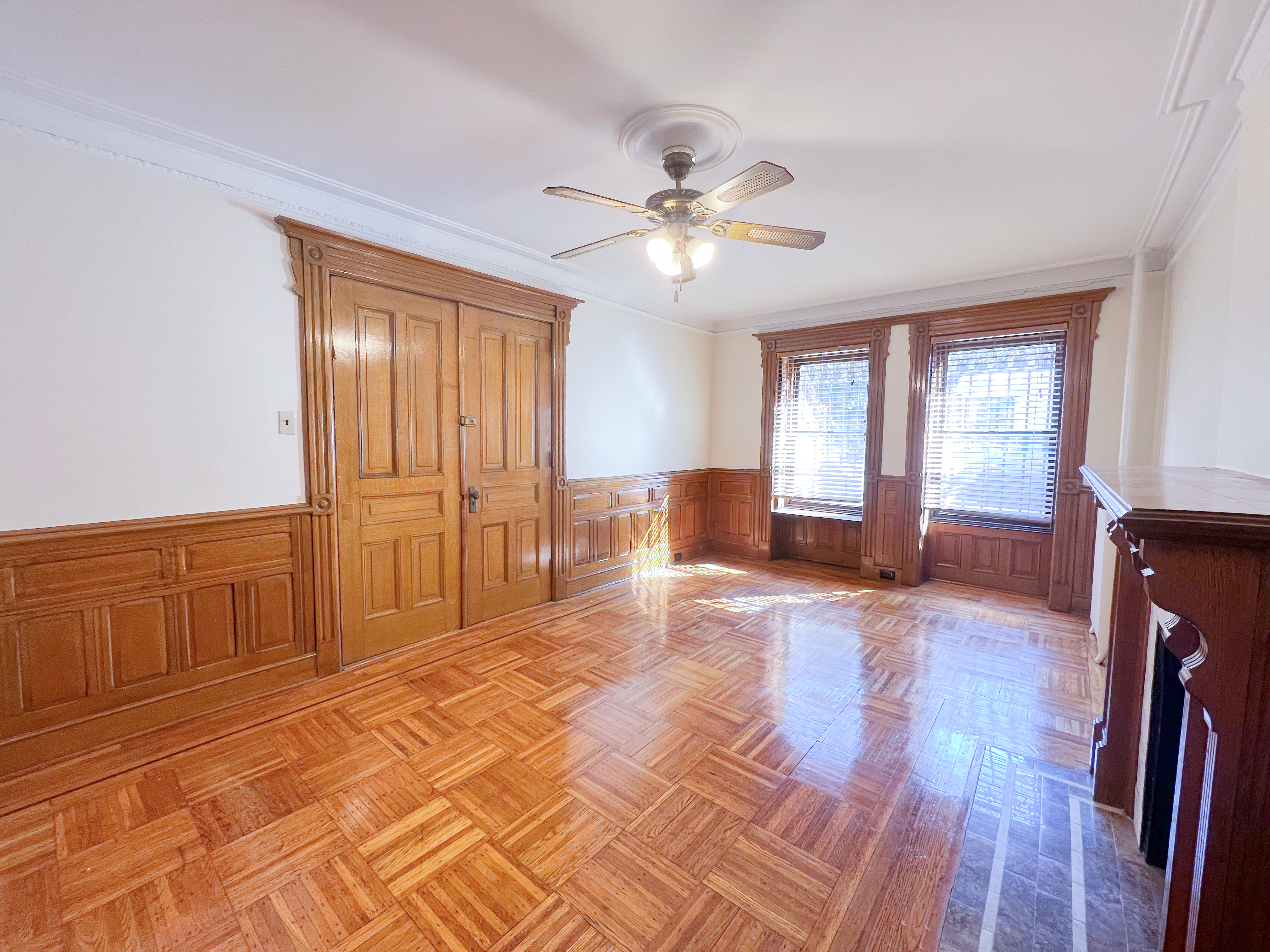 651 10th Street, Unit 1 Brooklyn, NY 11215 - Photo 3 of 12 a view of a livingroom with a chandelier fan and windows