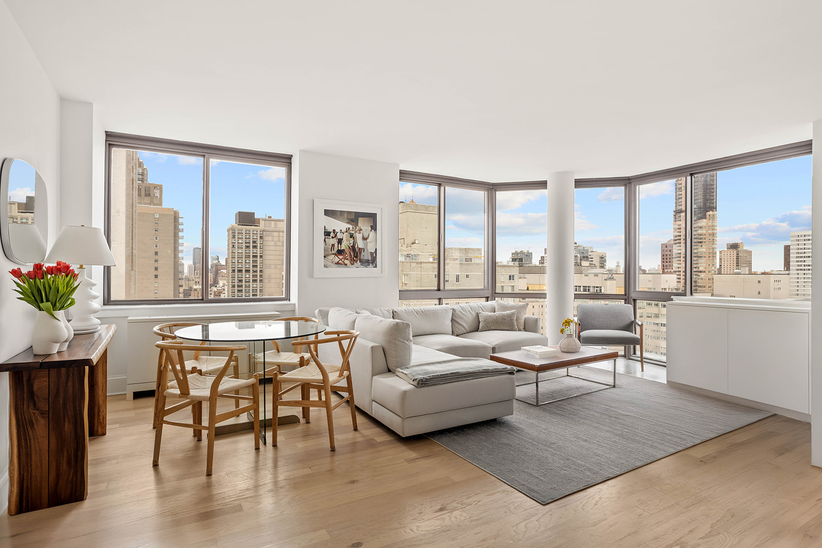 300 East 64th Street, Unit 26B Manhattan, NY 10065 - Photo 3 of 26 a living room with furniture and a floor to ceiling window